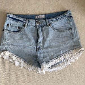 Free people blue jean shorts with lace trim
